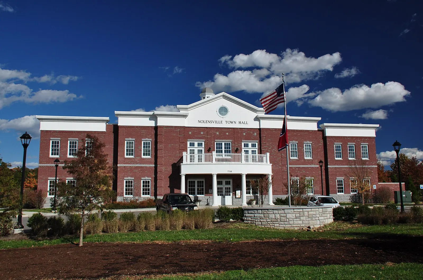 Nolensville's town government offices, a two-story brick building with a columned entrance and balcony at 7218 Nolensville Road in Nolensville, Tenn.