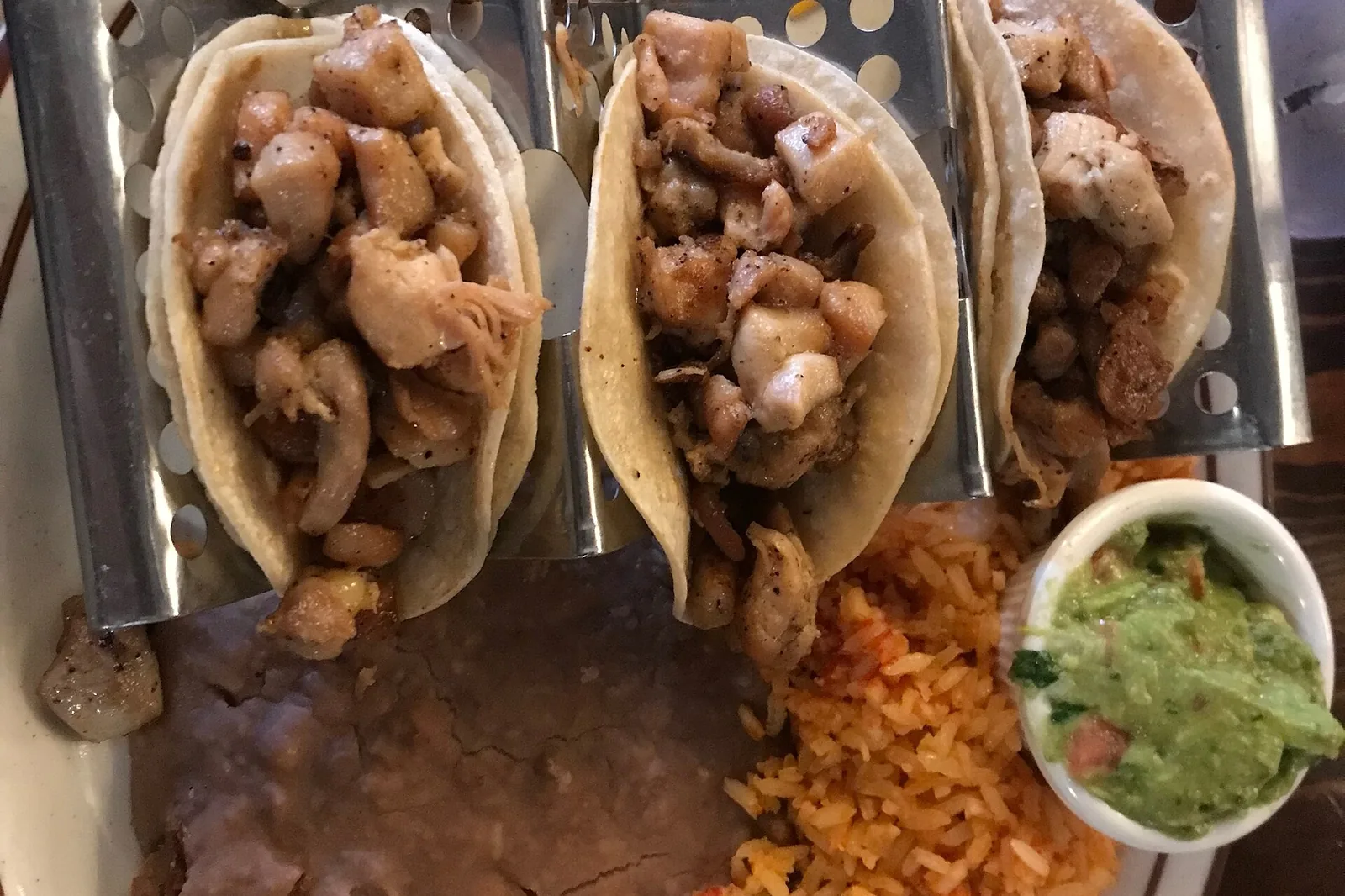Chicken tacos with rice, beans and guacamole at a restaurant in California. The photo was not taken in Brentwood.