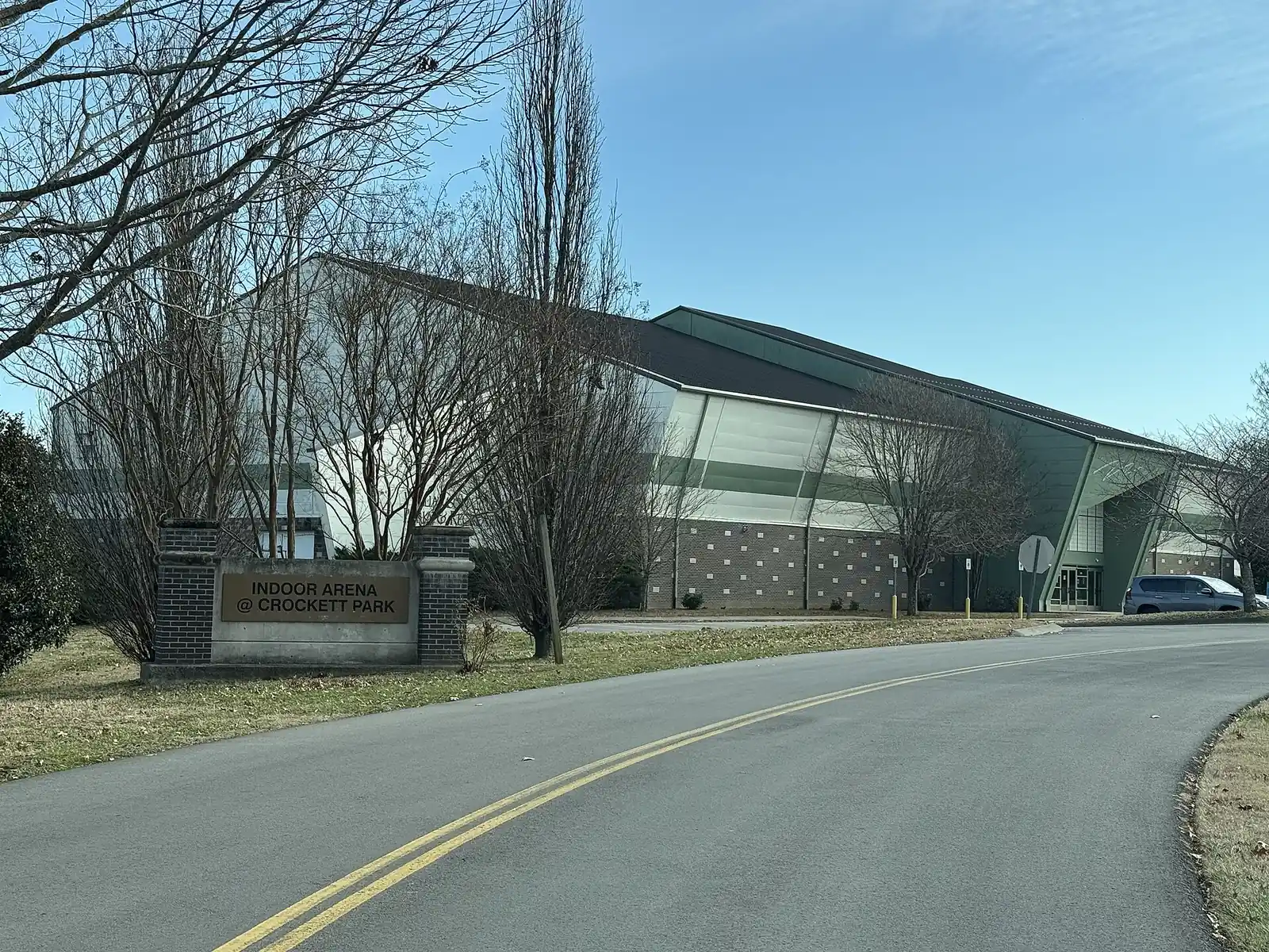 The indoor arena at Crockett Park, with its brick entrance sign beside the park road in central Brentwood.