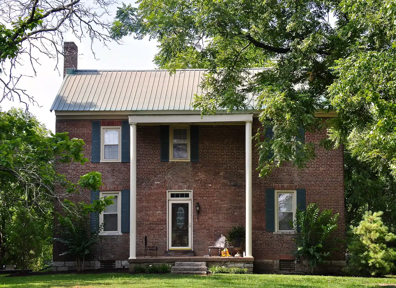 The John Frost House, a two-story brick house with a columned front porch on Old Smyrna Road east of Wilson Pike in Brentwood.
