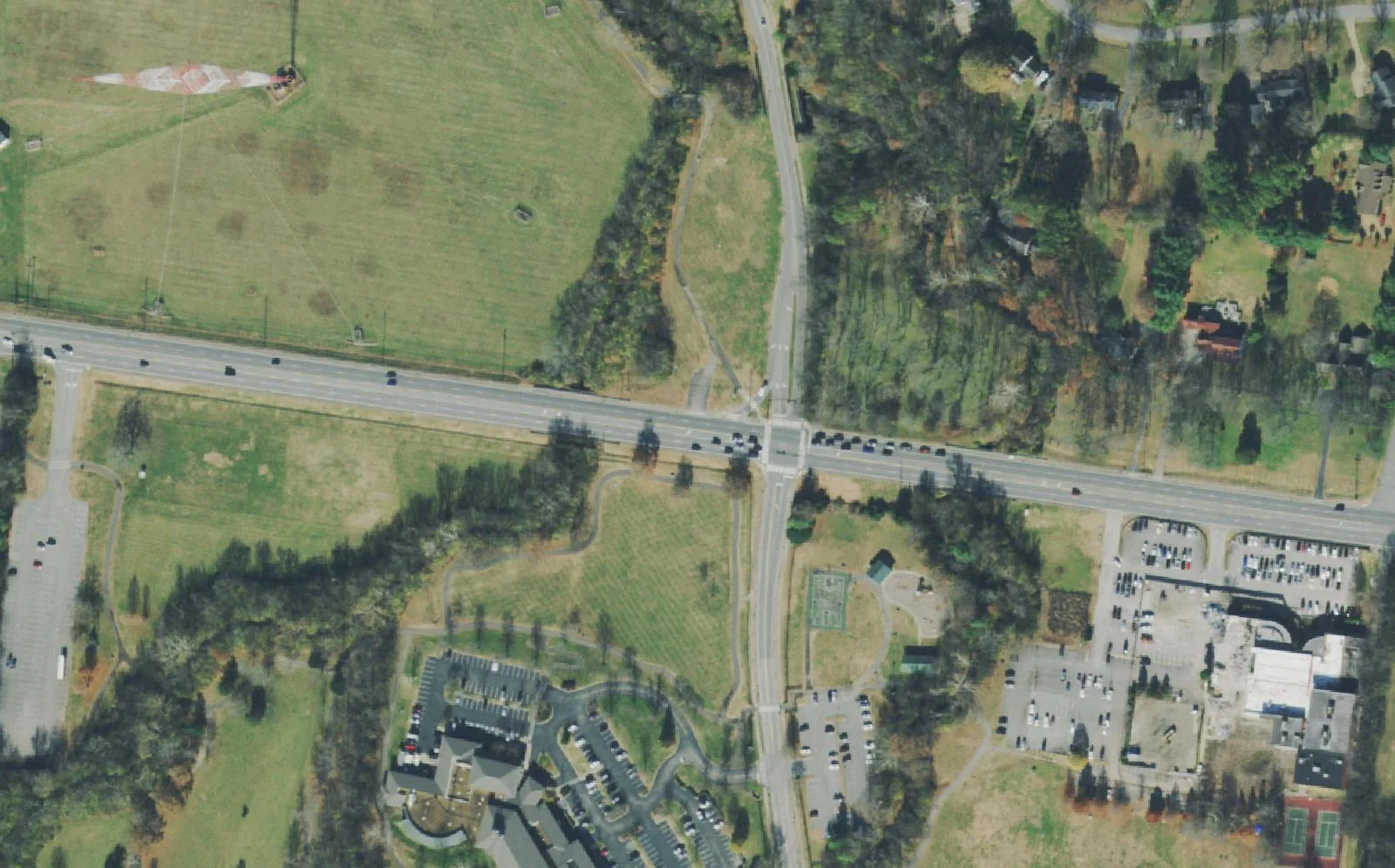 Concord Road east of I-65 in Brentwood, with the WSM radio tower field in Tower Park to the north and River Park's playground and paths along the Little Harpeth River to the south, seen from the air.