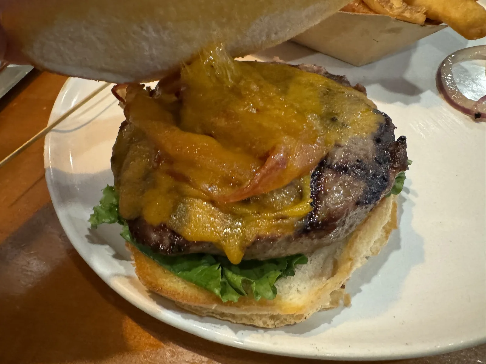 A bacon cheeseburger on a plate. The photo was not taken at a Brentwood restaurant.